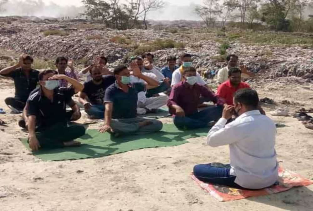 Youths done yoga near garbage on international yoga day 