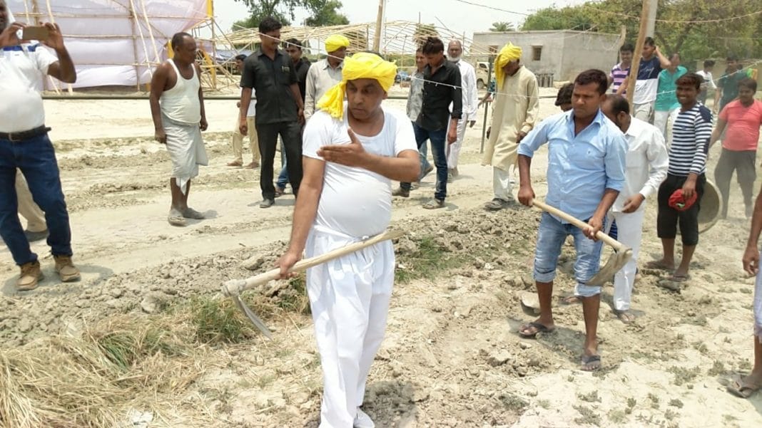 om prakash rajbhar come out for road construction with spade in his village