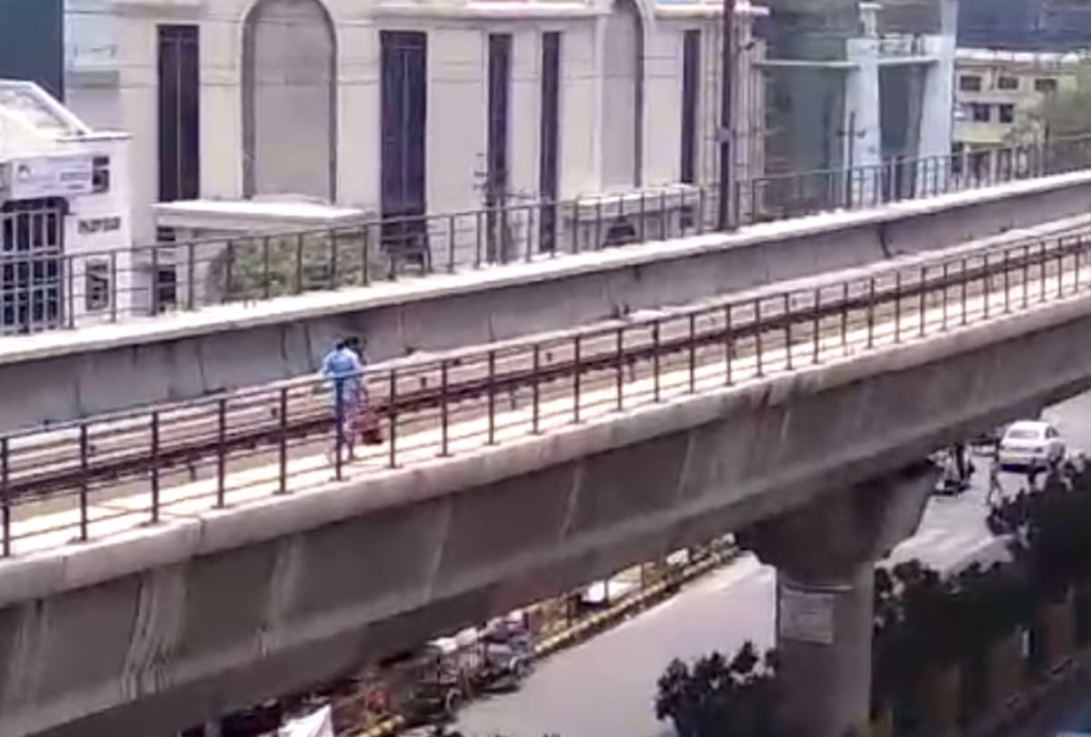 see pictures of lady walking on metro track from noida sector 15 to sector 16