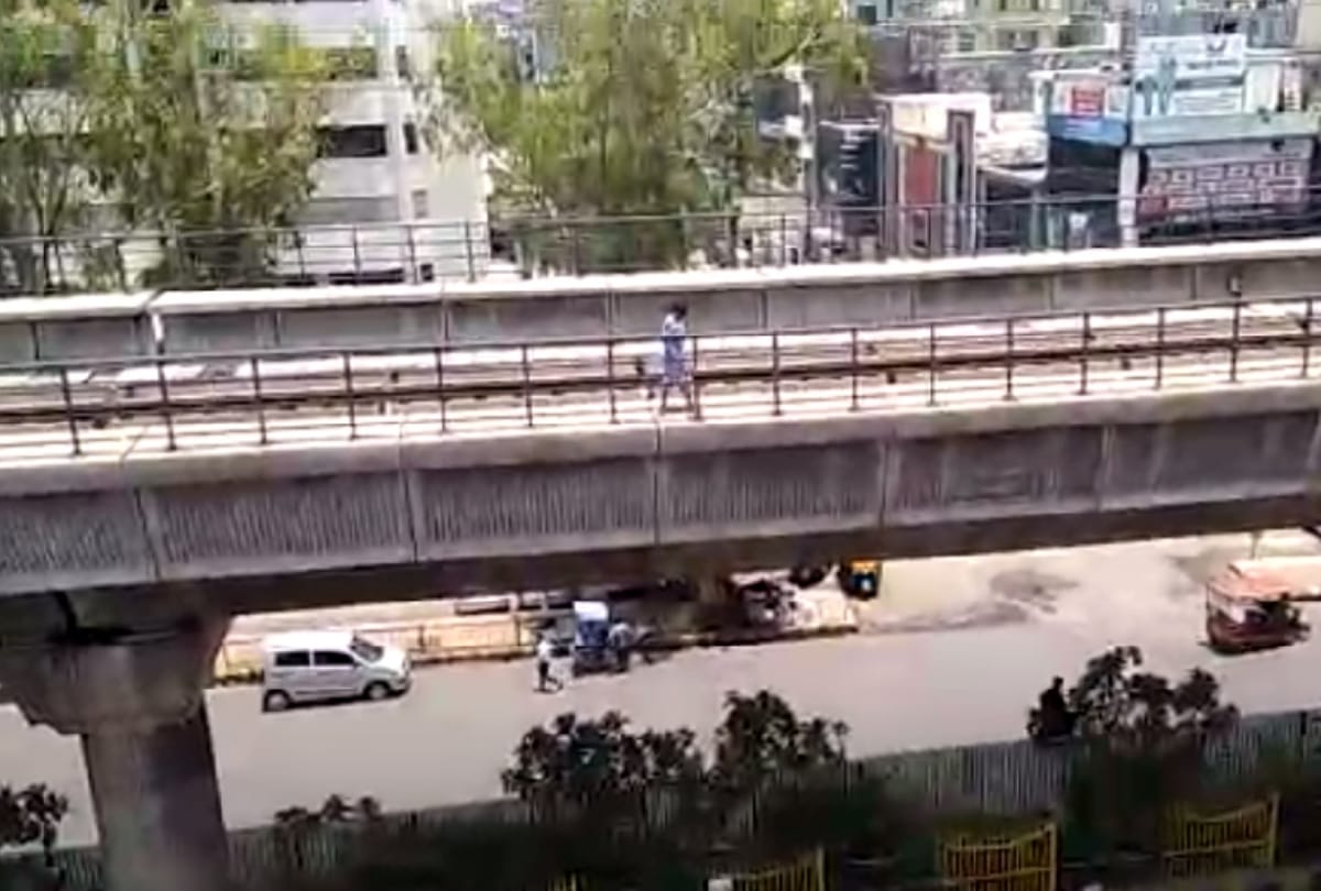 see pictures of lady walking on metro track from noida sector 15 to sector 16