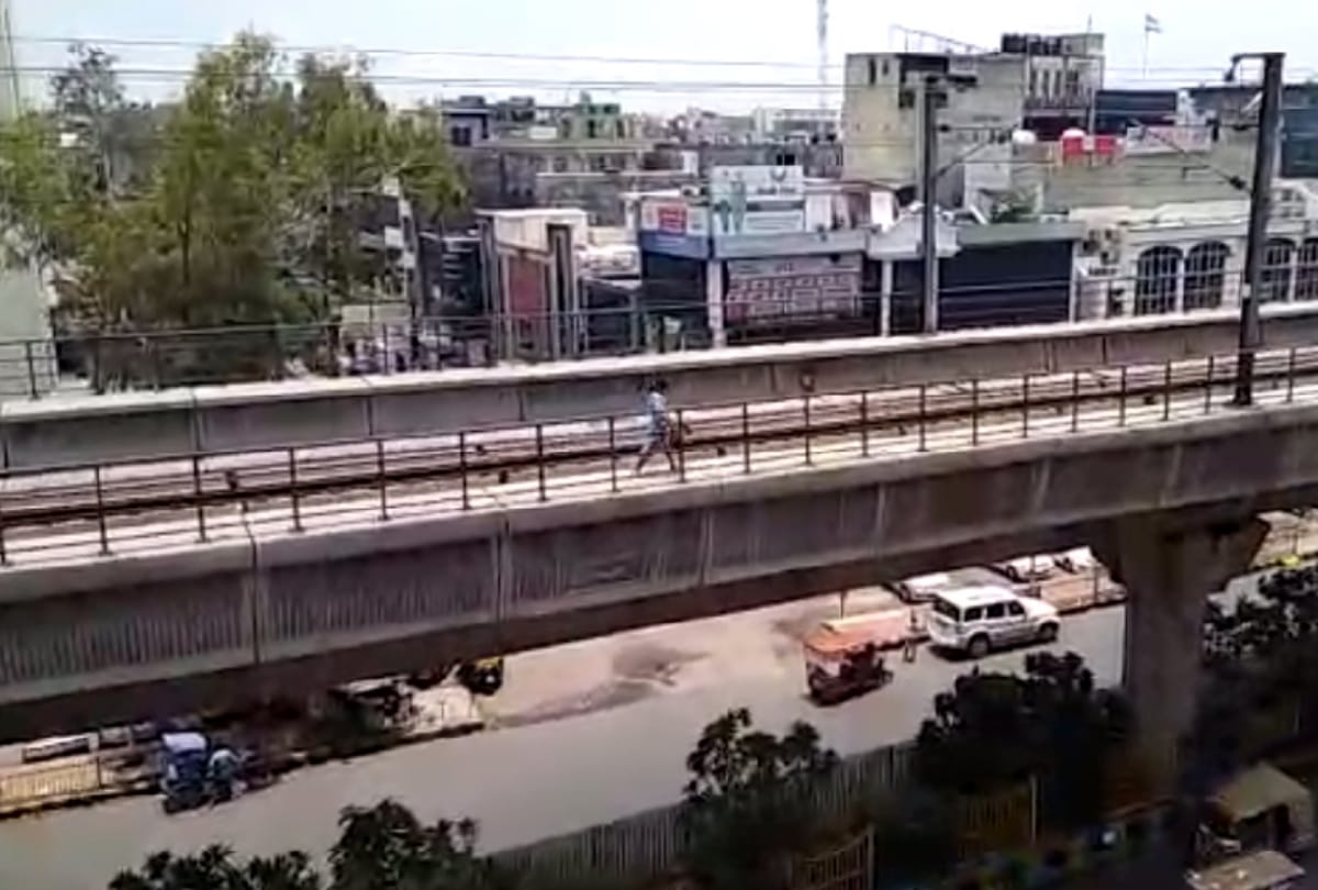 see pictures of lady walking on metro track from noida sector 15 to sector 16