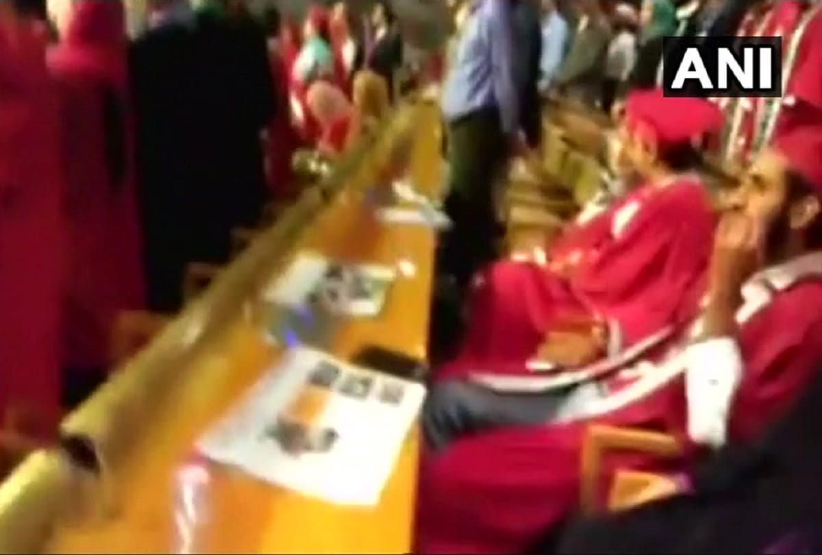 Some students of Sher-e-Kashmir University stay seated during the Indian national anthem 