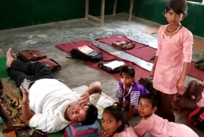Teachers in government school of shamli taking rest and kids digging in the sun