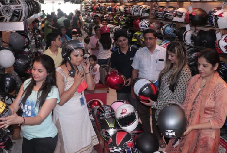 A crowd of women gathering in shops to buy helmets in chandigarh