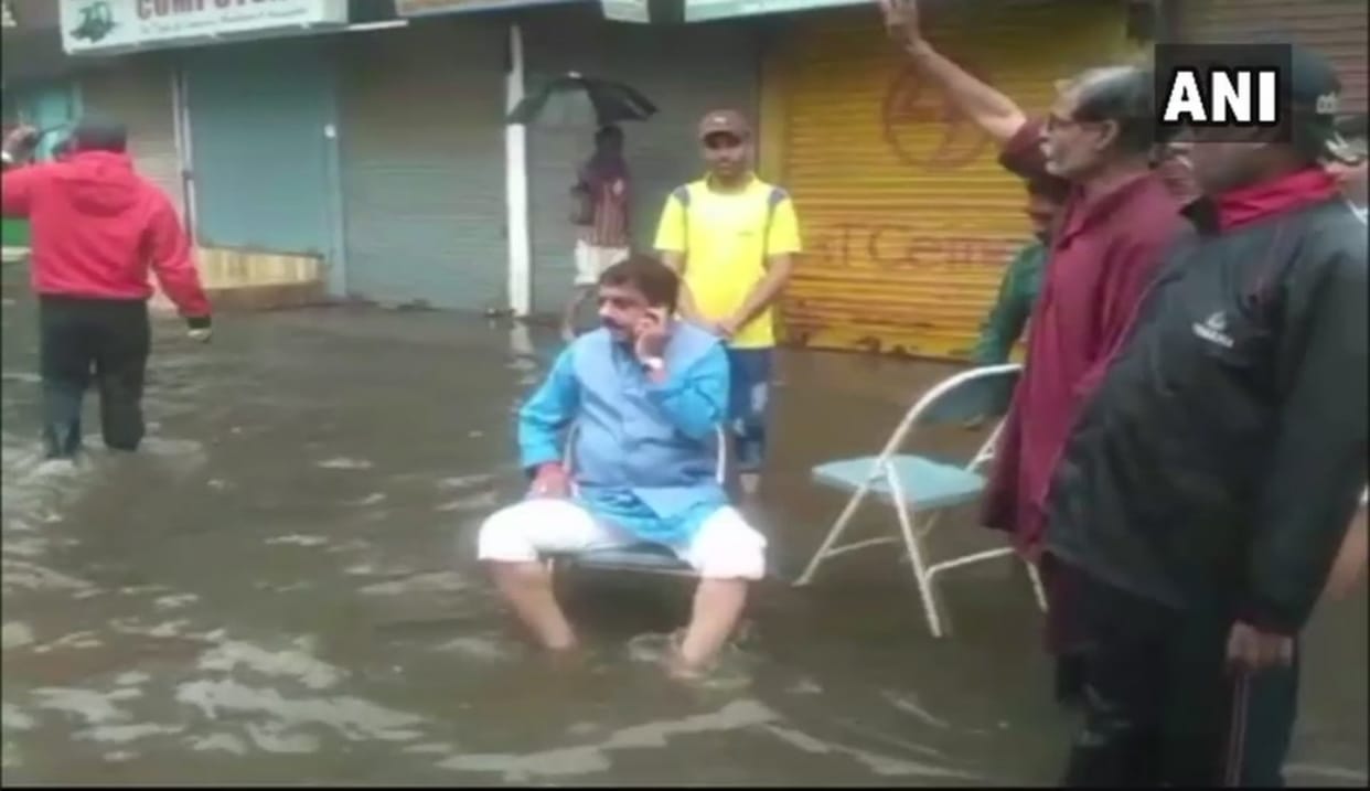 Heavy rain in bhopal Mayor Alok Sharma sits in the middle of a waterlogged street
