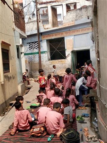  School's roof broken, kids study on road