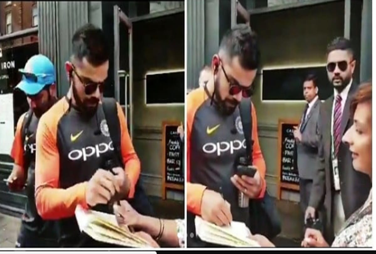 VIrat kohli gives auto graph to his female fan