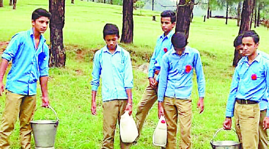 pupil carrying water instead of studying in school