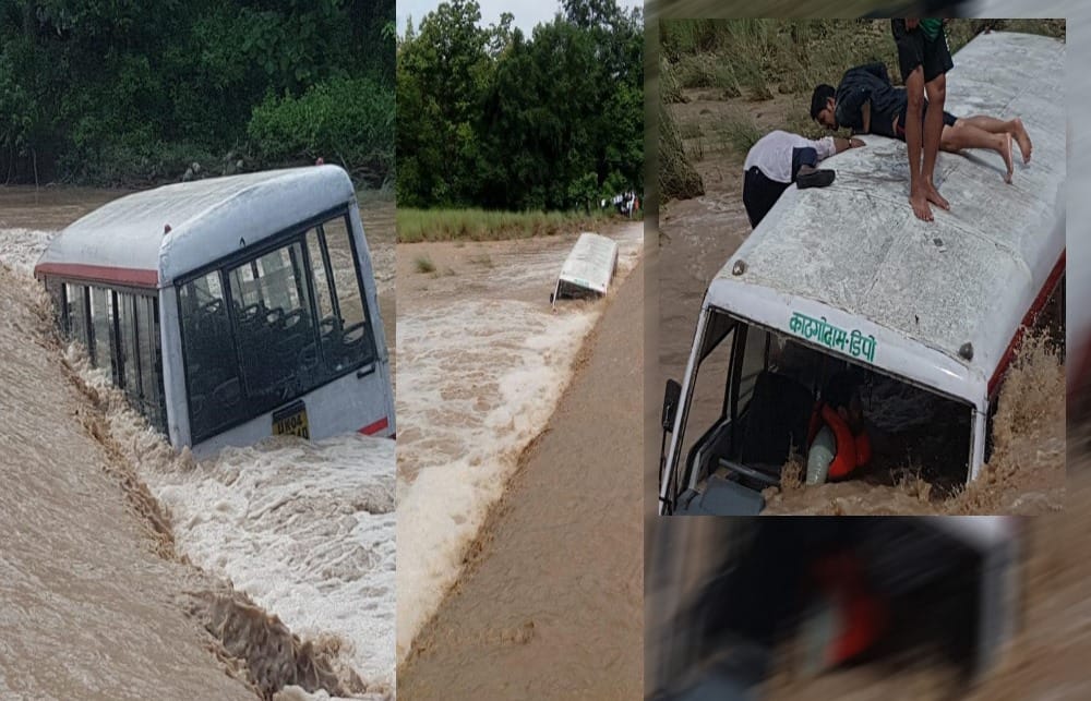 roadway bus submerged near a drain over flowing due to heavy rainfall