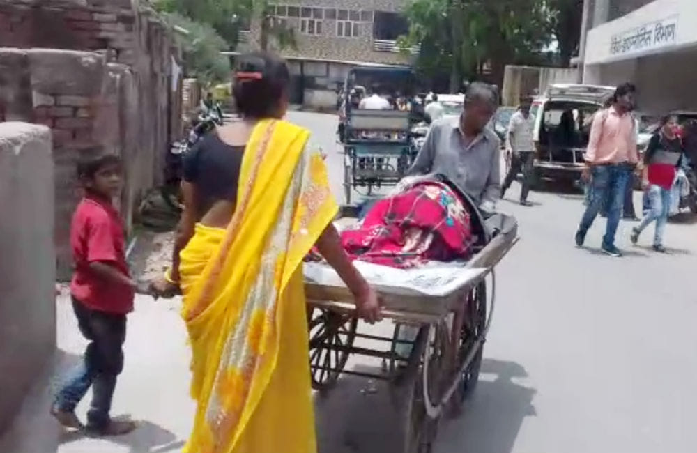 wife carries husband on thela to hospital for treatment in agra