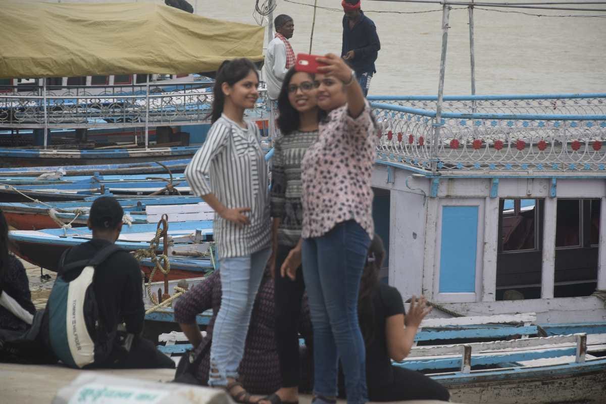 varanasi people enjoy on ganga ghat after clean weather