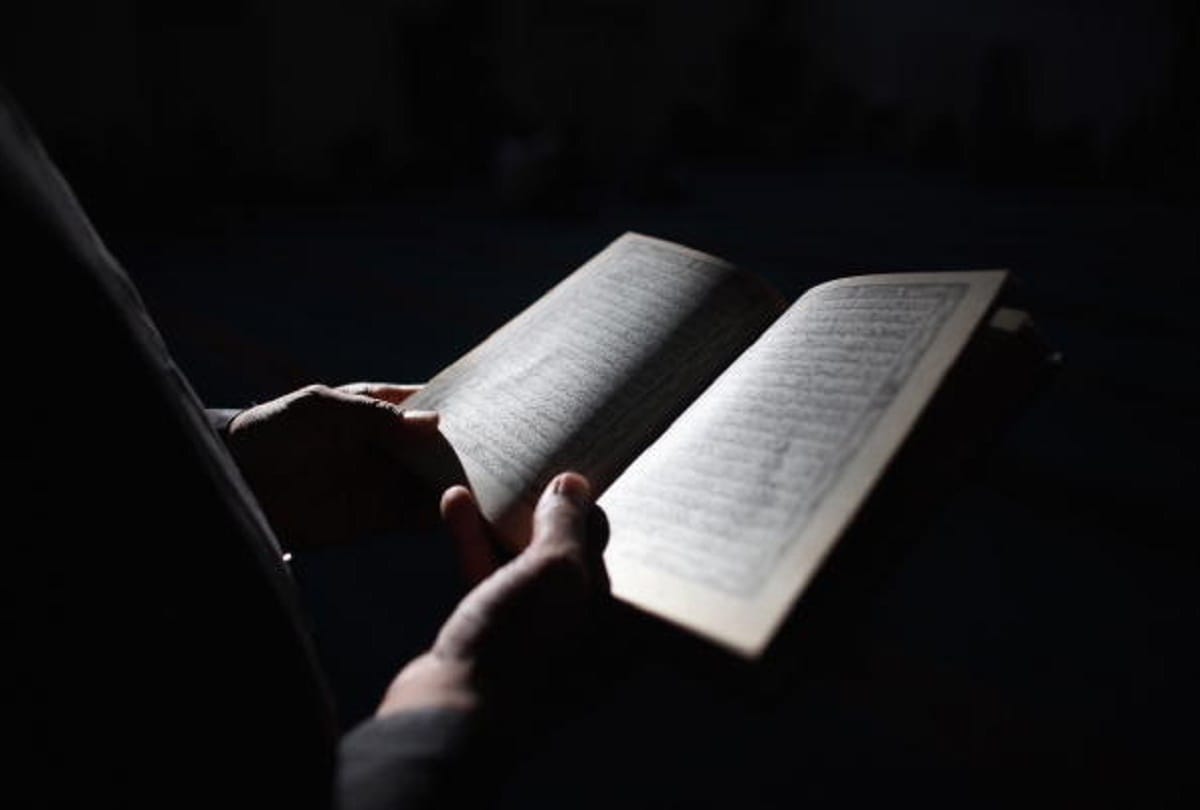 man placing holy quran in puja mandap in Bangladesh