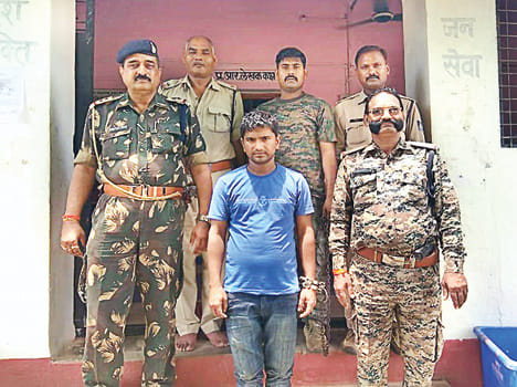 A member of the police handcuffed bandit Lalit Gang