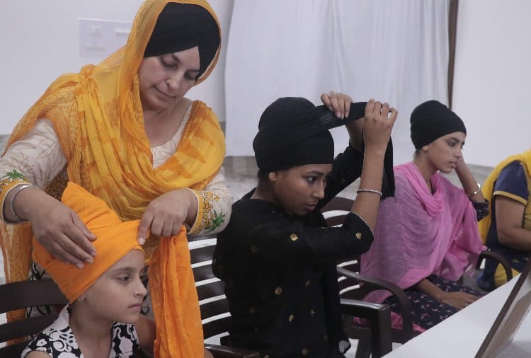 Girls Learning to Tie Turbon on Place of Wearing Helmet