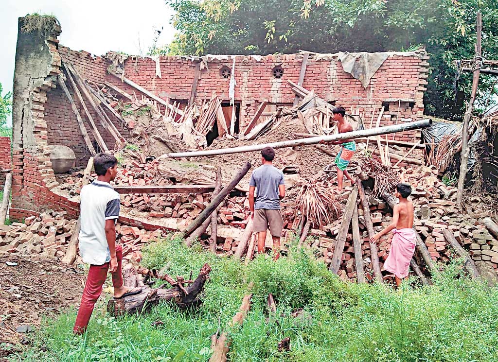 river on road, one building felt in amroha due to rain