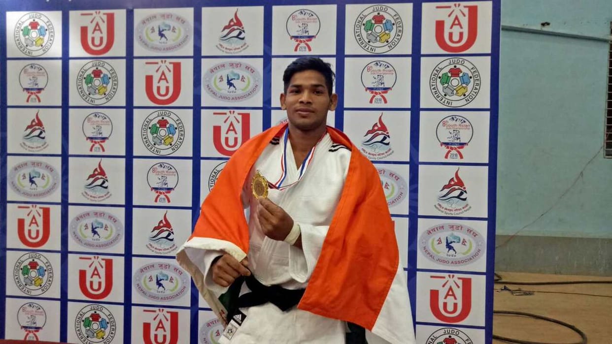 People celebrate the victory of Vijay Kumar Yadav for winning a Bronze medal in Judo at the Commonwealth Game