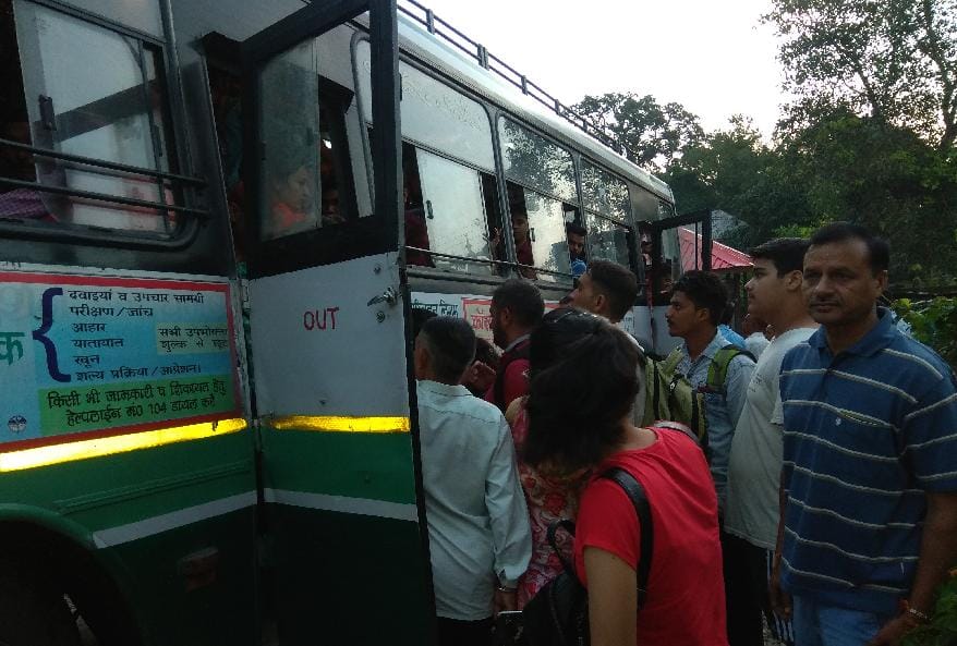 निगम की बस में ठूंस ठूंस कर भरे जा रहे यात्री