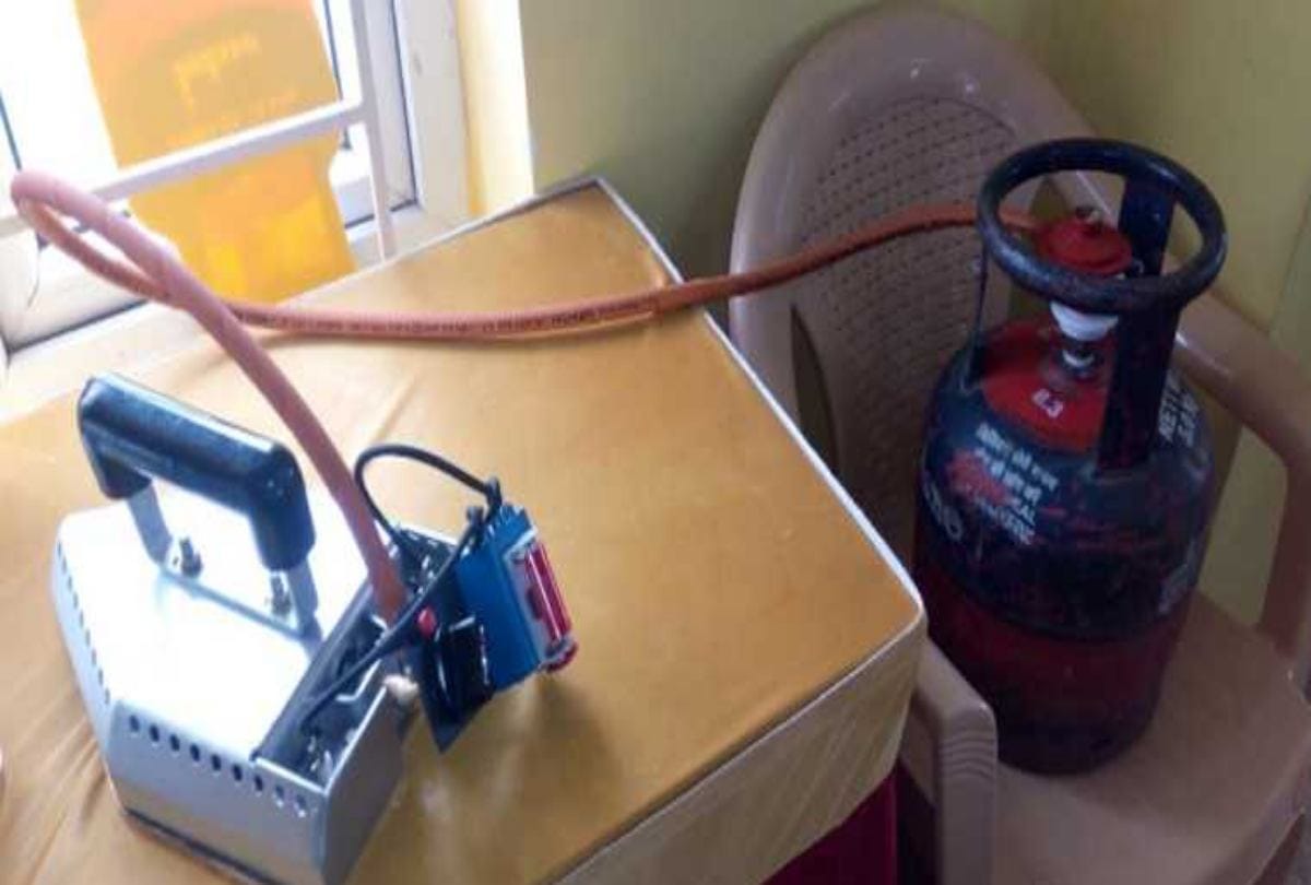 Luandrymen using LPG Iron Box to press clothes insted coal and electric iron