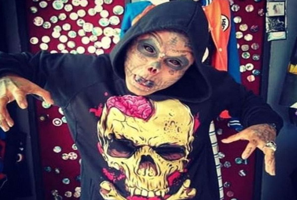 Body modification man cut his ears and half nose to look like skull