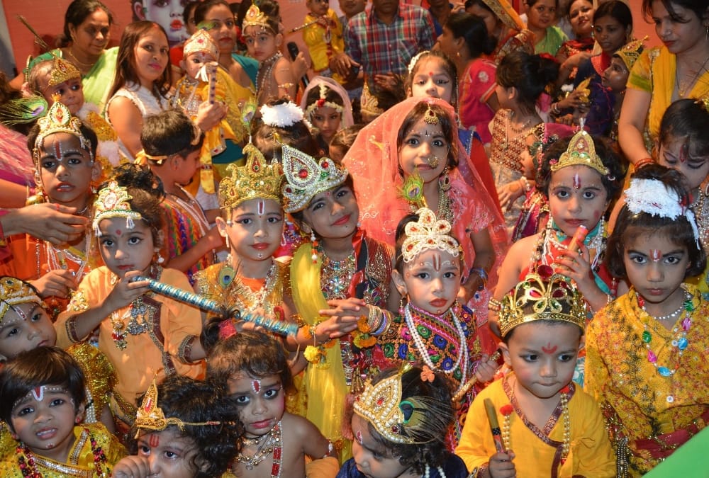 muslim woman decorated her daughter in radha attire.