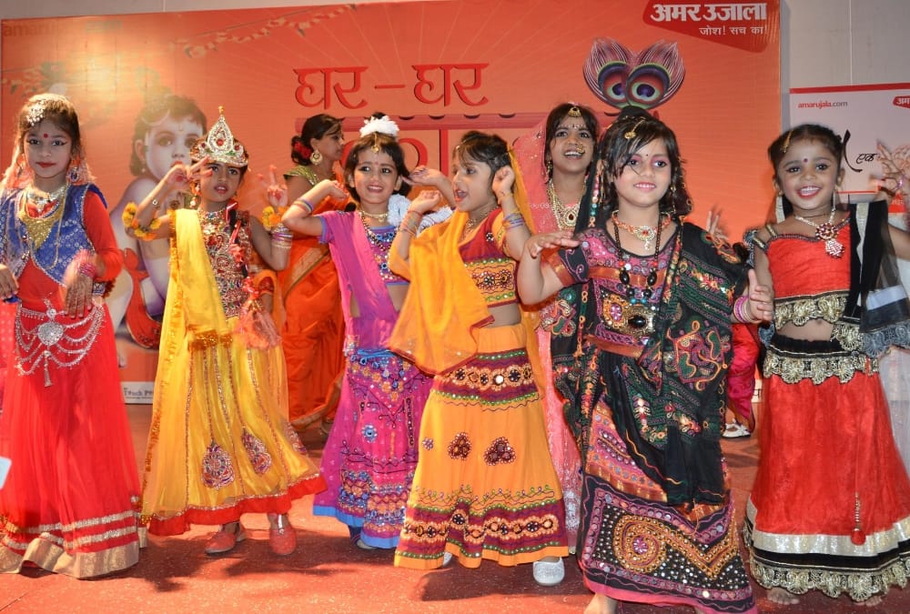 muslim woman decorated her daughter in radha attire.