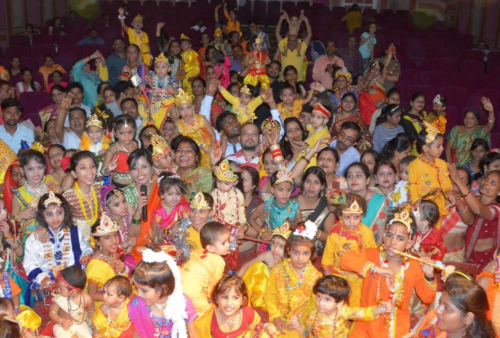 muslim woman decorated her daughter in radha attire.