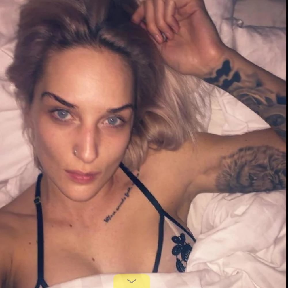 musician Indiana pose topless in front of a World War memorial