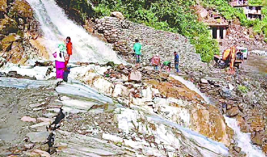 The waterfall falling from the hill blocked the road