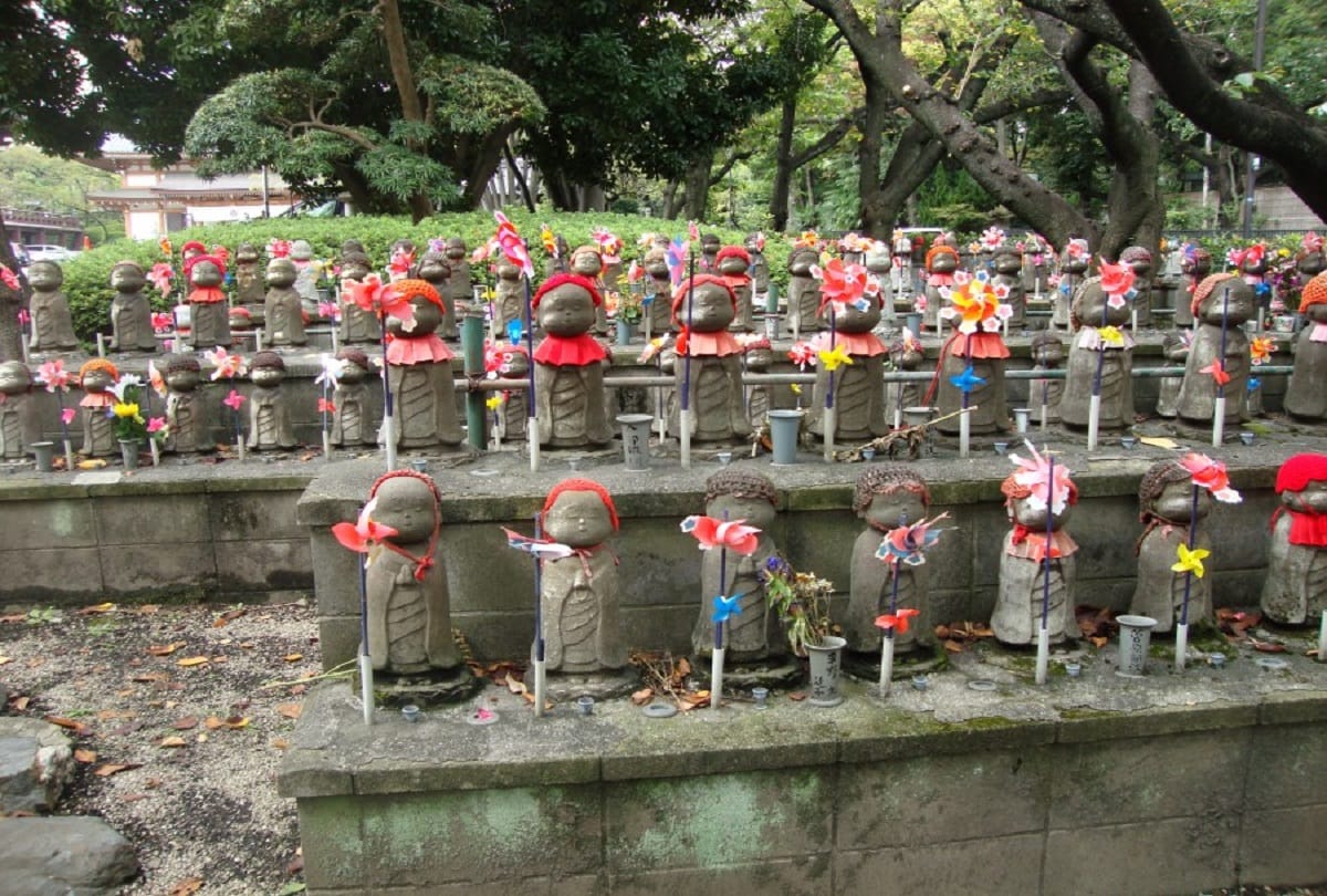 Japan: Prayers are performed for rebirth in Buddhist temple, statue of unborn children