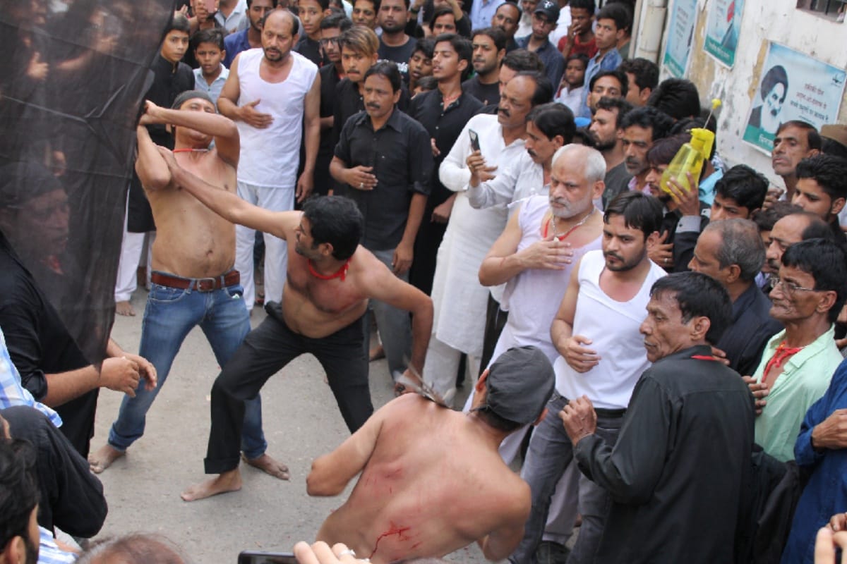 Shia Sogwaras weeds with churns and chains during Mourning of Muharram