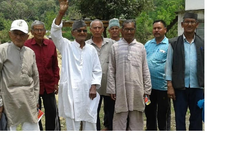 Villagers perform on the road demanding on the road