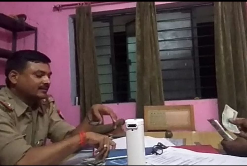 video of police men distributing bribe money viral.