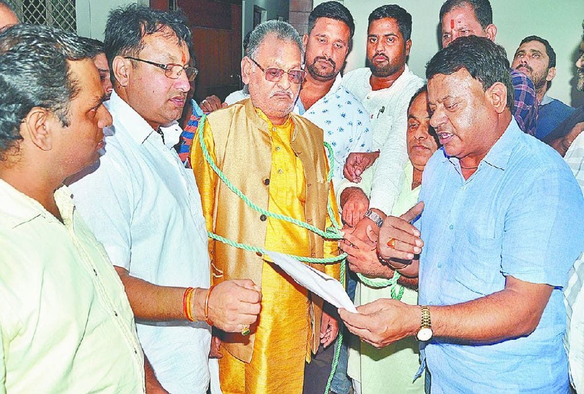 BJP legislator jagan prasad garg is symbolically tied in a rope