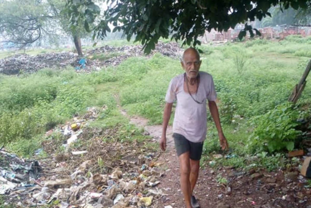 two mens are giving their service to community by filling potholes on roads