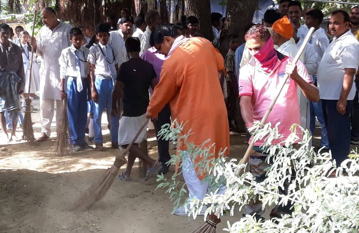 Leader take broom for photography in varanasi