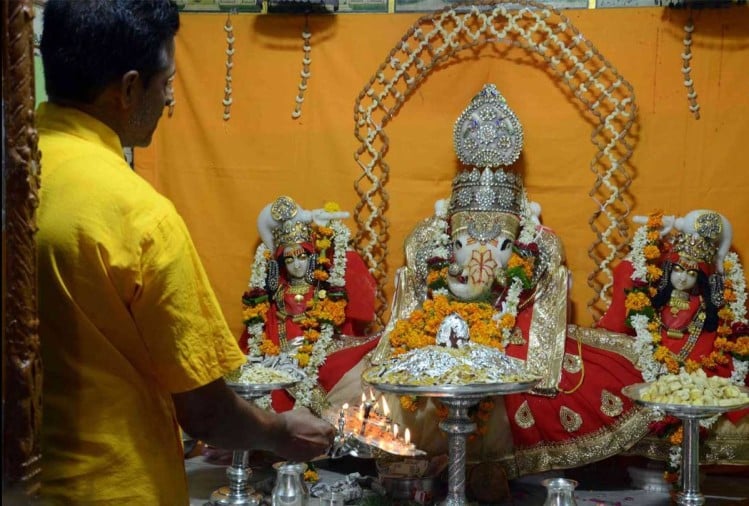 A beautifully decorated Puja Ghar with idols and flowers