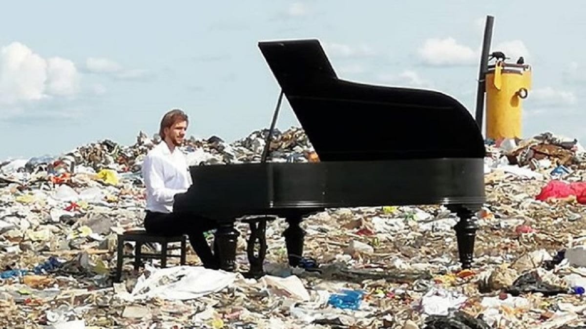 Artist played piano on a litter pile to raise awareness of plastic threats in russia