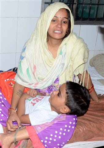 Woman carrying child from Aligarh Women's Hospital, disorder