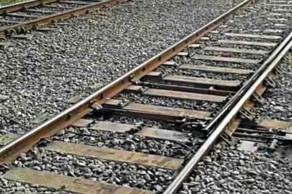 Worker lying next to train because contractor did not give money
