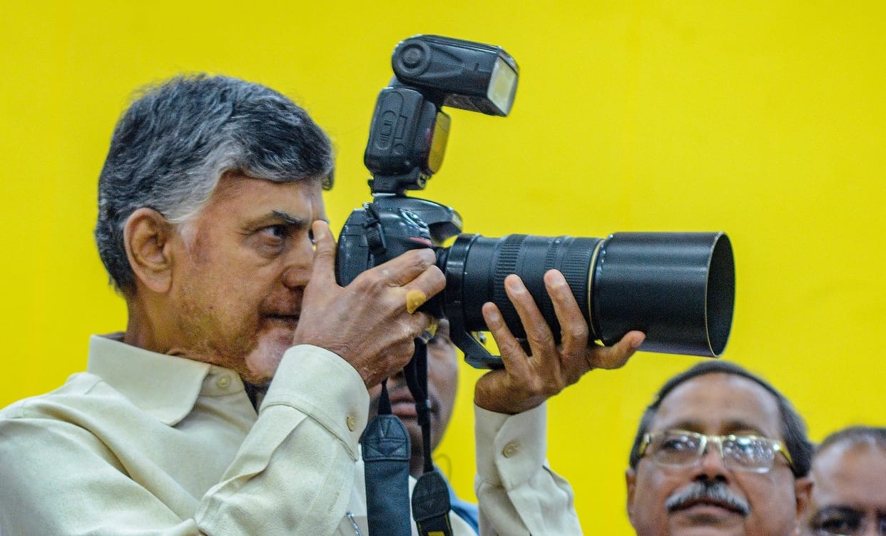Andhra Pradesh Chief Minister N. Chandrababu Naidu while focusing through camera