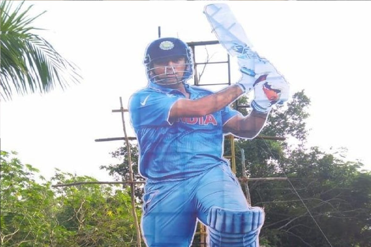 ms dhoni 35 feet cutout stands in front of the cricket stadium