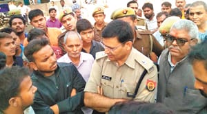 angry villagers try to stop the highway