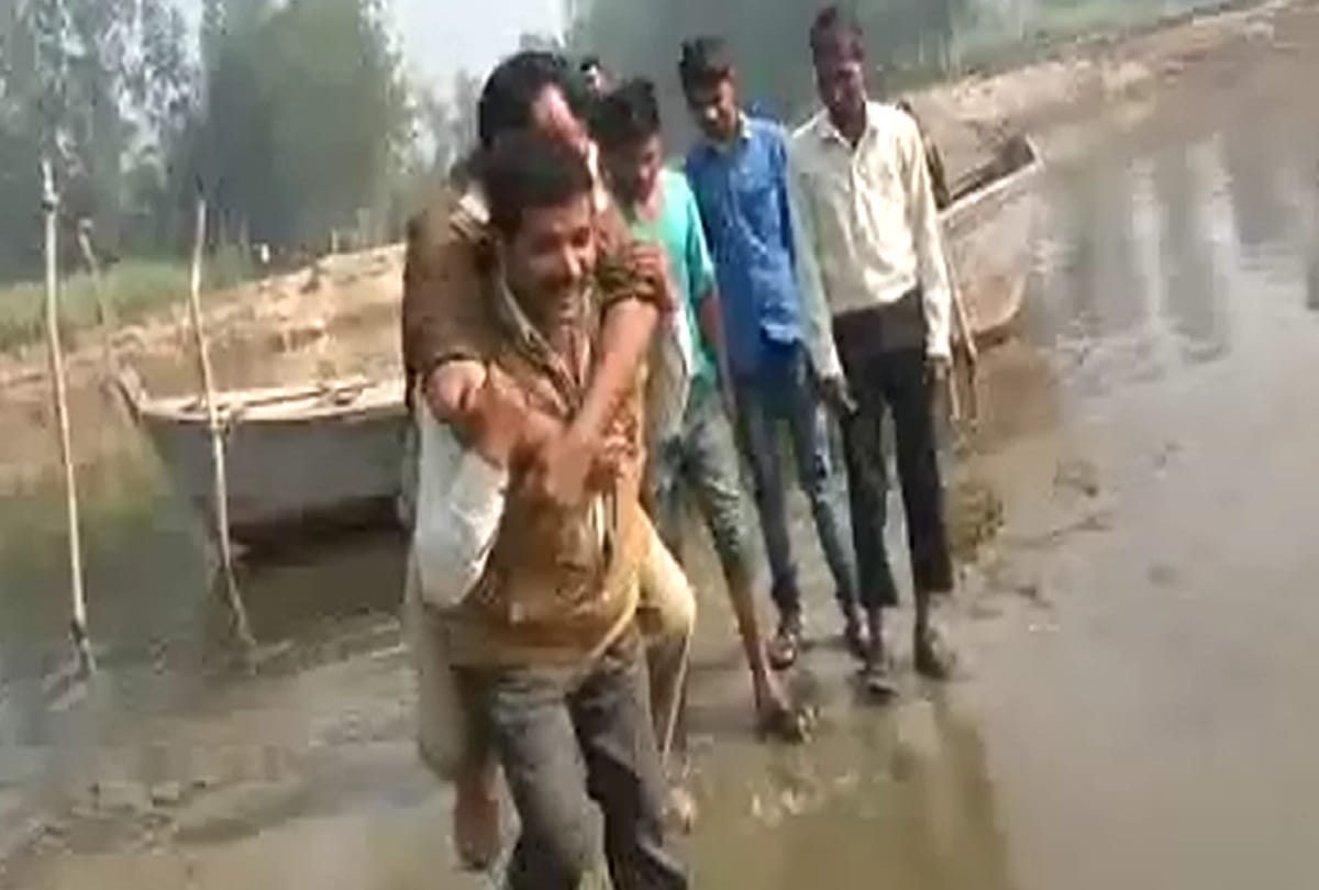 sub inspector crossed the river bank on climb on man back in moradabad
