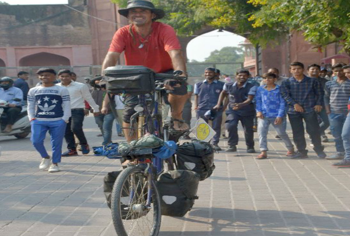 tourist come to agra from Spain with his unique bicycle