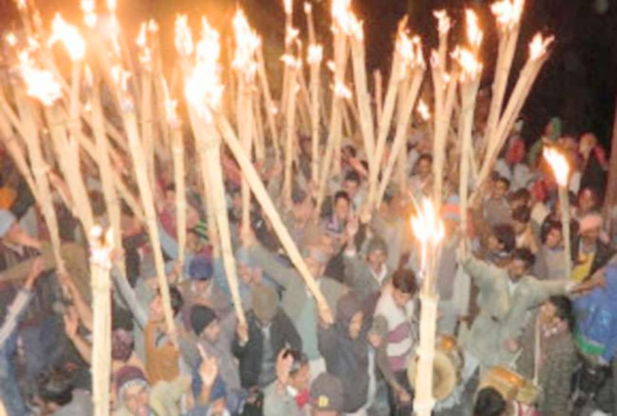 People dance with burning torches in kullu himachal