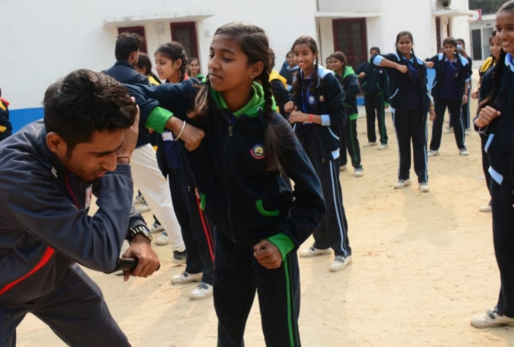 Aprajita gives defence training to school children.