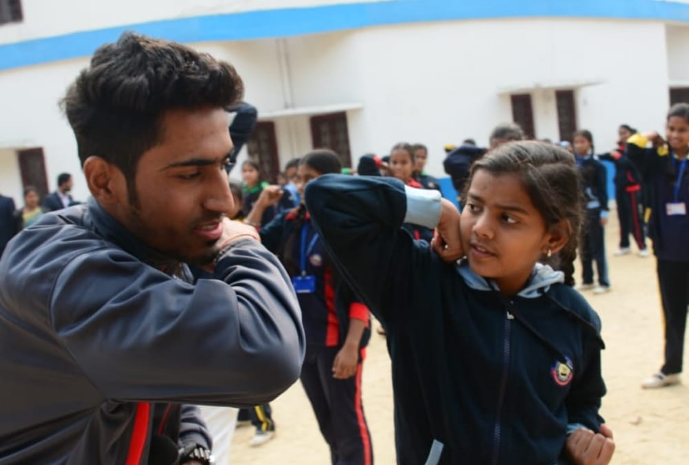 Aprajita gives defence training to school children.