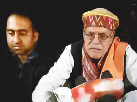 BJP legislator sitting on the dais with villagers