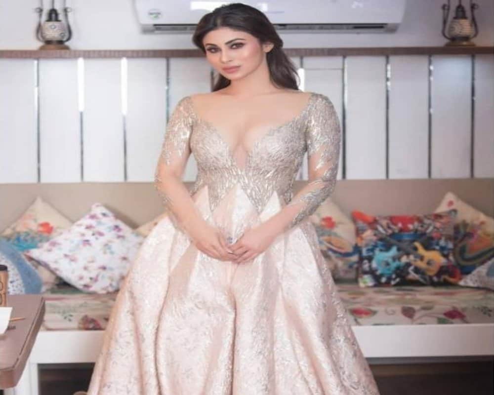 mouni roy look hot in her bold silver deep neck dress