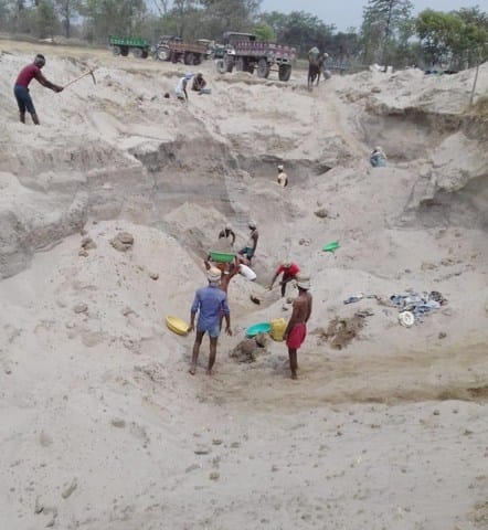 The sand out of the river under the shadow of the farm